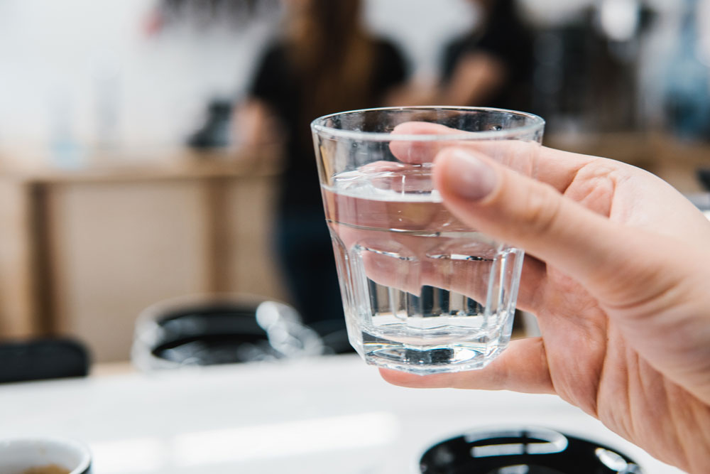 Glass of drinking water from tank